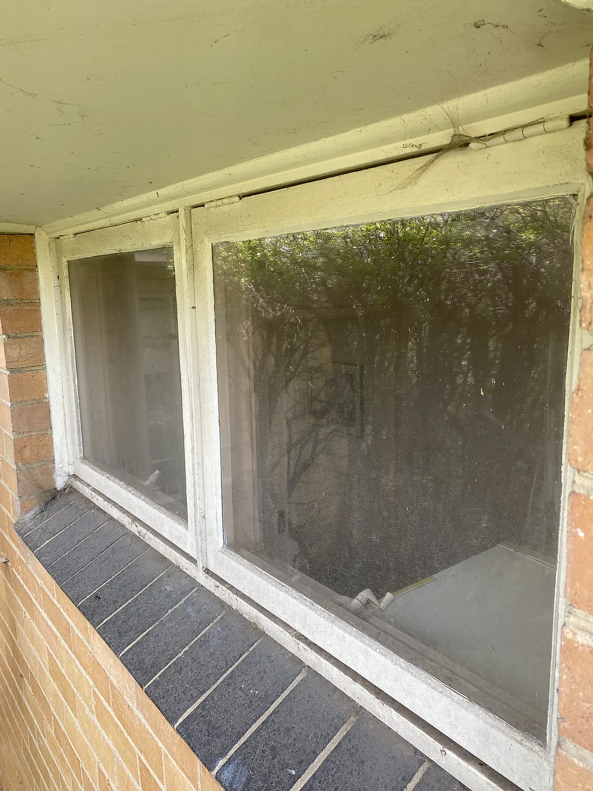 Exterior windows dulled by a film of grime before cleaning